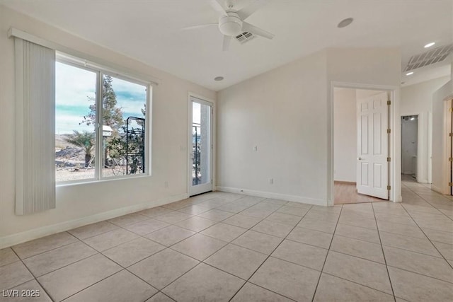 tiled spare room featuring ceiling fan