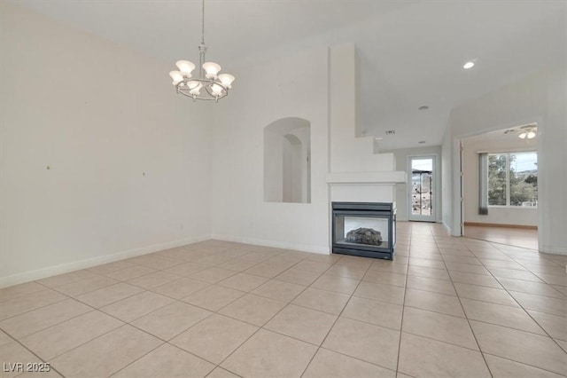 unfurnished living room featuring a multi sided fireplace, light tile patterned floors, and a notable chandelier