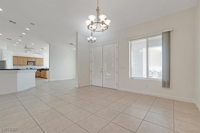 interior space featuring ceiling fan with notable chandelier and light tile patterned flooring