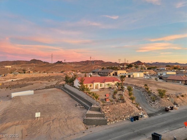 aerial view at dusk featuring a mountain view