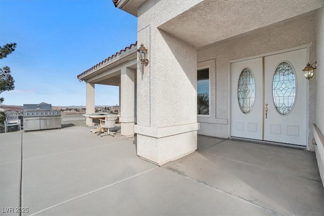 entrance to property with a patio area