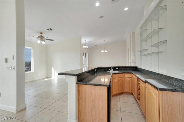 kitchen featuring ceiling fan with notable chandelier, sink, light tile patterned floors, light brown cabinetry, and kitchen peninsula