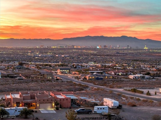 aerial view at dusk featuring a mountain view