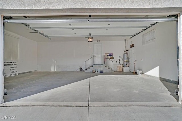 garage with a garage door opener and water heater