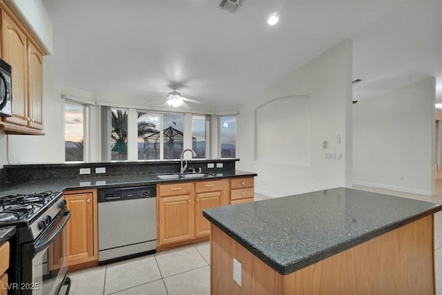 kitchen featuring ceiling fan, dishwasher, sink, black gas stove, and light tile patterned floors