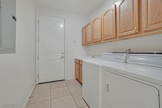 washroom featuring sink, cabinets, electric panel, washer and clothes dryer, and light tile patterned flooring