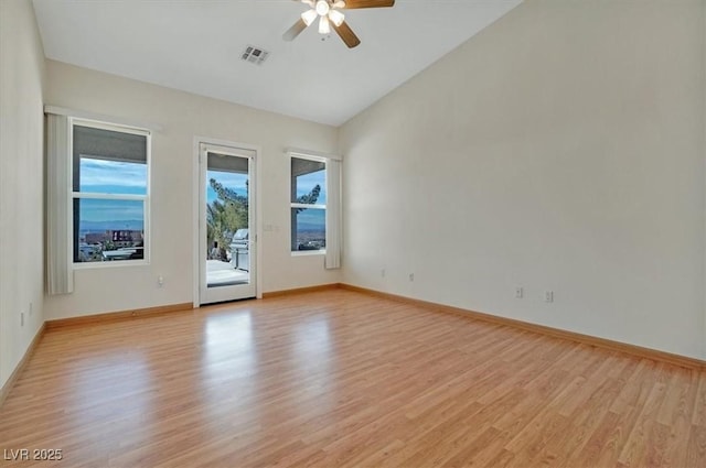 unfurnished room with ceiling fan, light wood-type flooring, and lofted ceiling