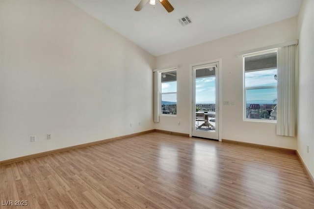 empty room featuring ceiling fan, light hardwood / wood-style flooring, and lofted ceiling