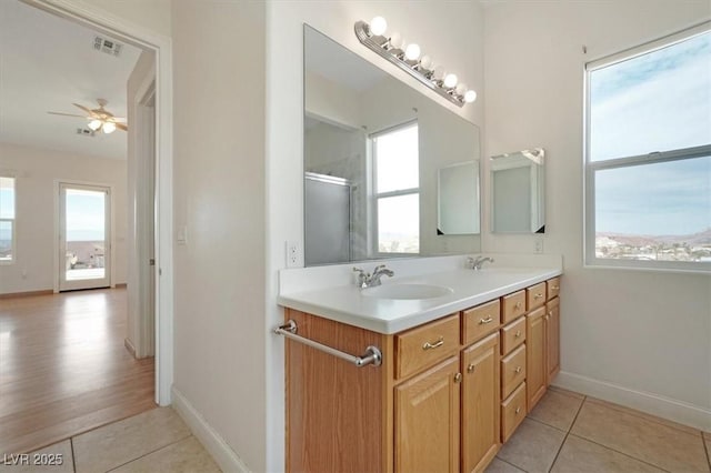 bathroom featuring tile patterned floors, vanity, a wealth of natural light, and ceiling fan