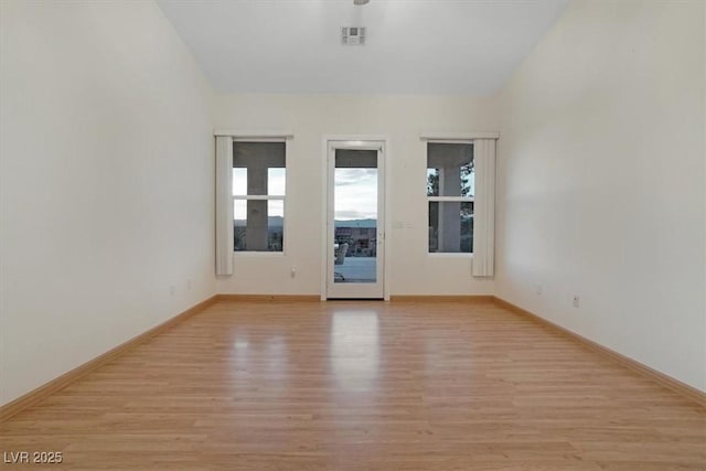 empty room with light hardwood / wood-style flooring