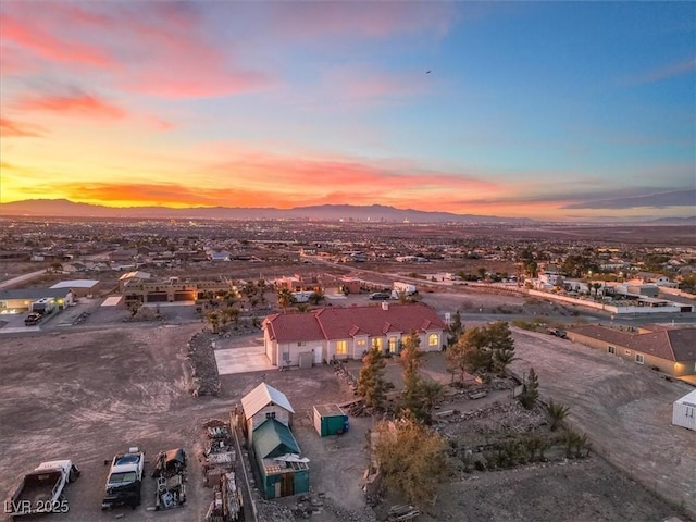 aerial view at dusk featuring a mountain view