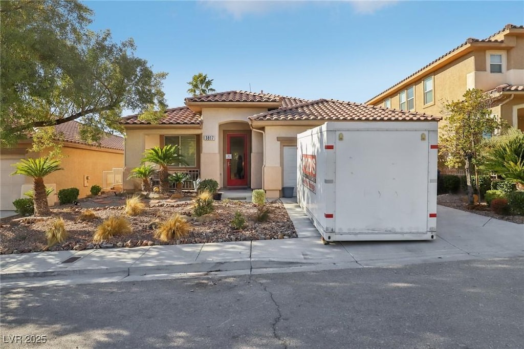 mediterranean / spanish-style home featuring a garage