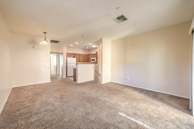 unfurnished living room featuring light colored carpet