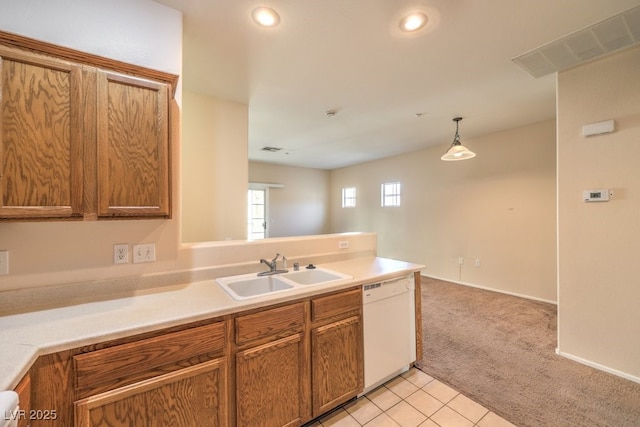 kitchen featuring light carpet, pendant lighting, white dishwasher, and sink