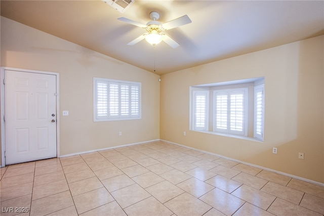 unfurnished room featuring ceiling fan, vaulted ceiling, and light tile patterned floors