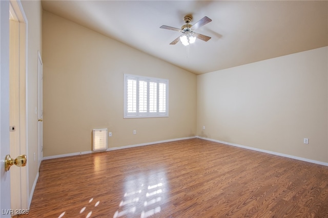 empty room with hardwood / wood-style flooring, ceiling fan, and lofted ceiling