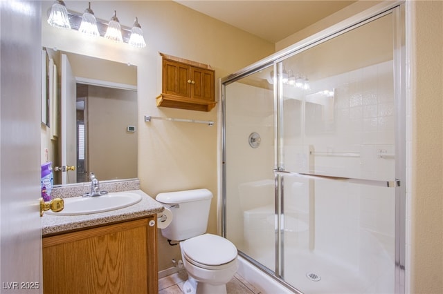 bathroom featuring an enclosed shower, vanity, tile patterned flooring, and toilet