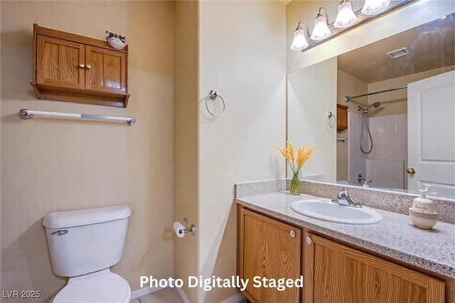 bathroom with vanity, a shower, and toilet