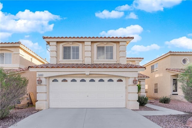 mediterranean / spanish home with a garage