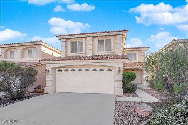 mediterranean / spanish-style house with a garage