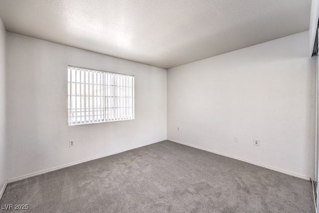 carpeted empty room with a textured ceiling