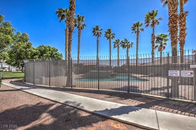 view of gate with a patio area and a community pool