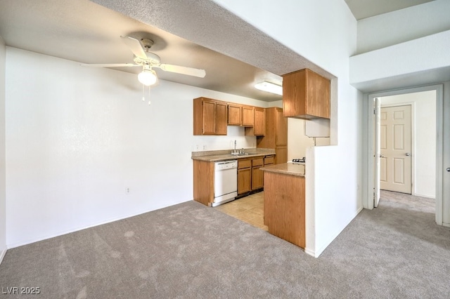 kitchen with white dishwasher, ceiling fan, light colored carpet, and sink