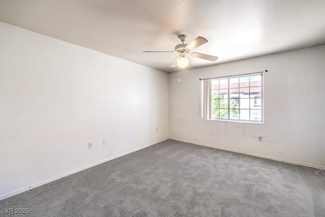 carpeted spare room featuring ceiling fan and a textured ceiling