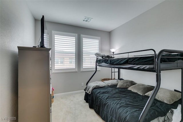 bedroom featuring light carpet