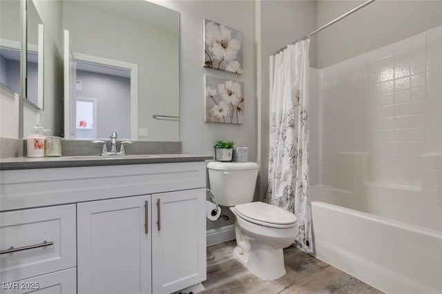 full bathroom featuring hardwood / wood-style flooring, shower / bath combination with curtain, toilet, and vanity