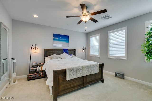 bedroom with ceiling fan and light carpet