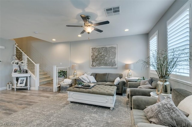 living room featuring ceiling fan and wood-type flooring