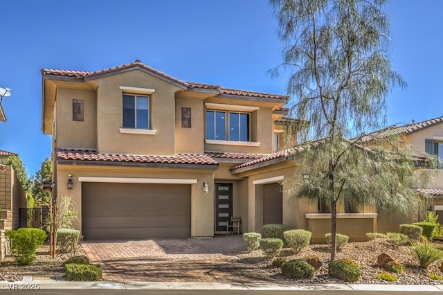 mediterranean / spanish-style home featuring a garage