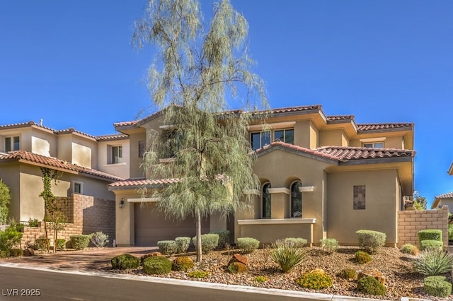 mediterranean / spanish-style house with a garage