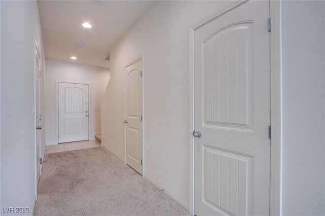 hallway with light colored carpet