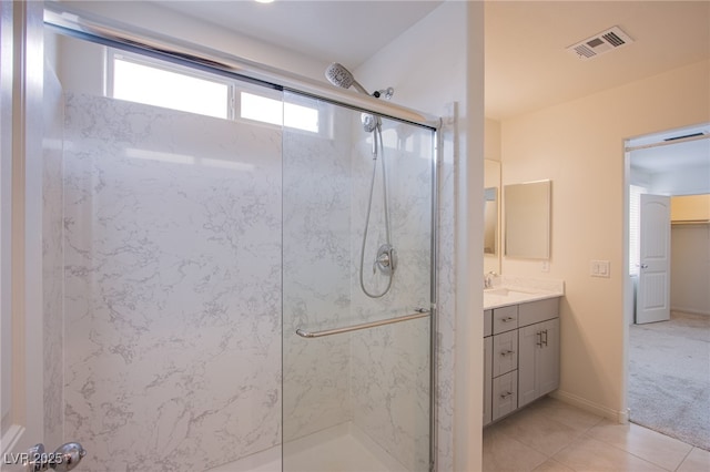 bathroom featuring tile patterned floors, vanity, and walk in shower