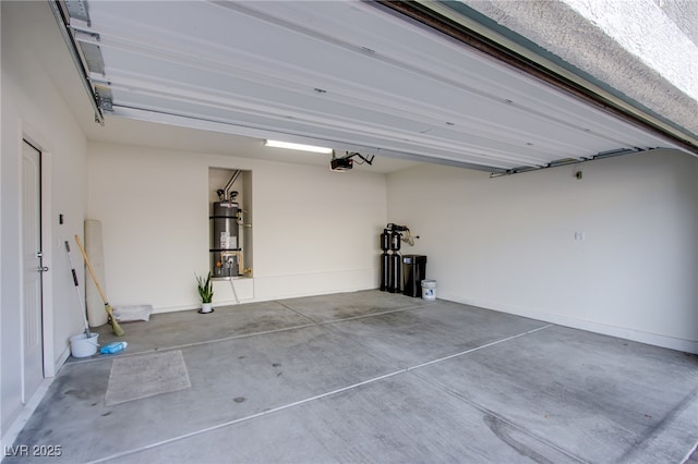 garage featuring strapped water heater and a garage door opener