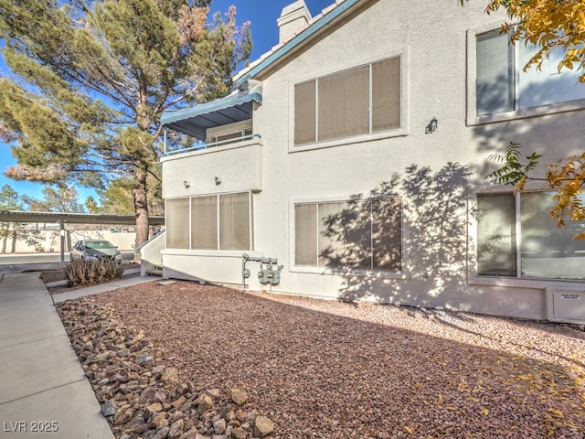 view of side of property with a balcony