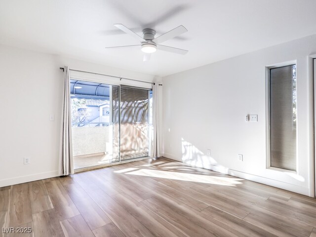 unfurnished room with light wood-type flooring and ceiling fan