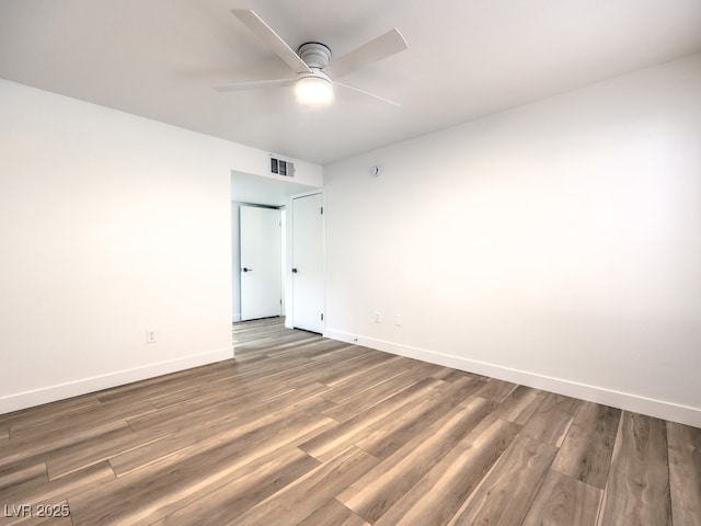 spare room featuring wood-type flooring and ceiling fan