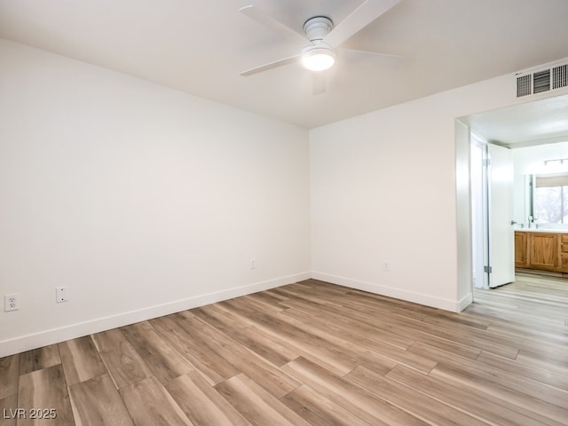 spare room with ceiling fan and light hardwood / wood-style floors