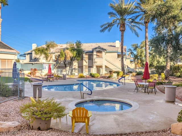 view of swimming pool with a patio area and a hot tub