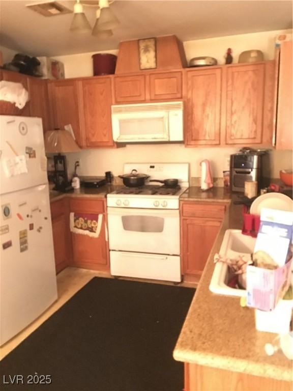 kitchen with white appliances and ceiling fan