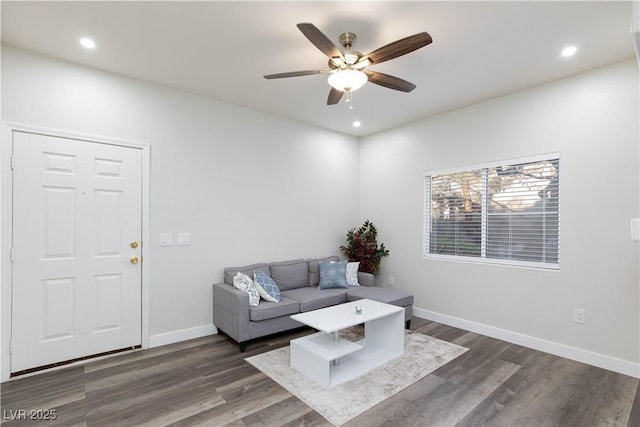 living room with dark hardwood / wood-style floors and ceiling fan