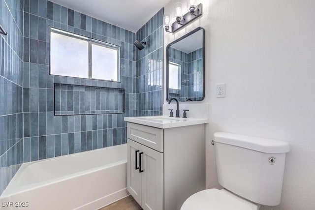 full bathroom featuring vanity, toilet, and tiled shower / bath