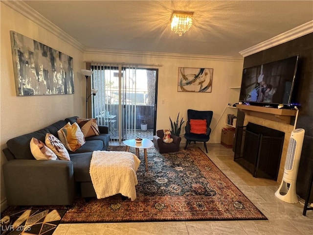 living room with a tile fireplace, ornamental molding, and a notable chandelier