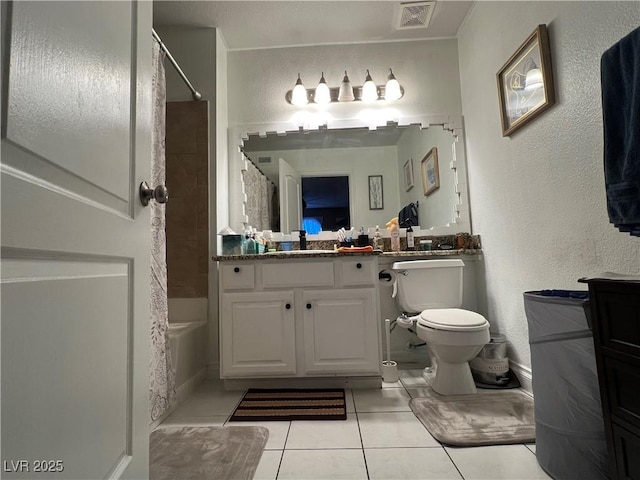 full bathroom with tile patterned floors, shower / bath combo with shower curtain, vanity, and toilet