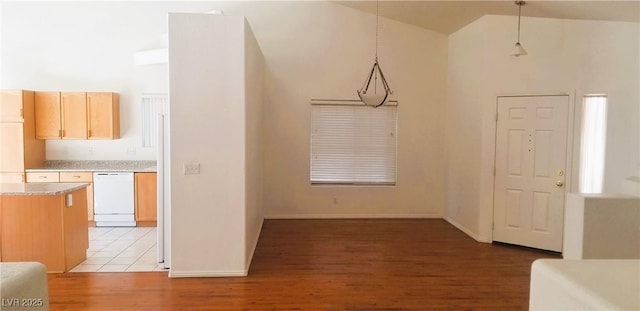 foyer entrance with high vaulted ceiling and light hardwood / wood-style flooring