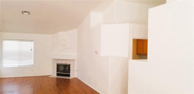 unfurnished living room with a fireplace and hardwood / wood-style flooring