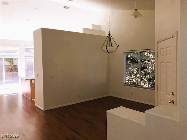 unfurnished dining area featuring dark hardwood / wood-style floors